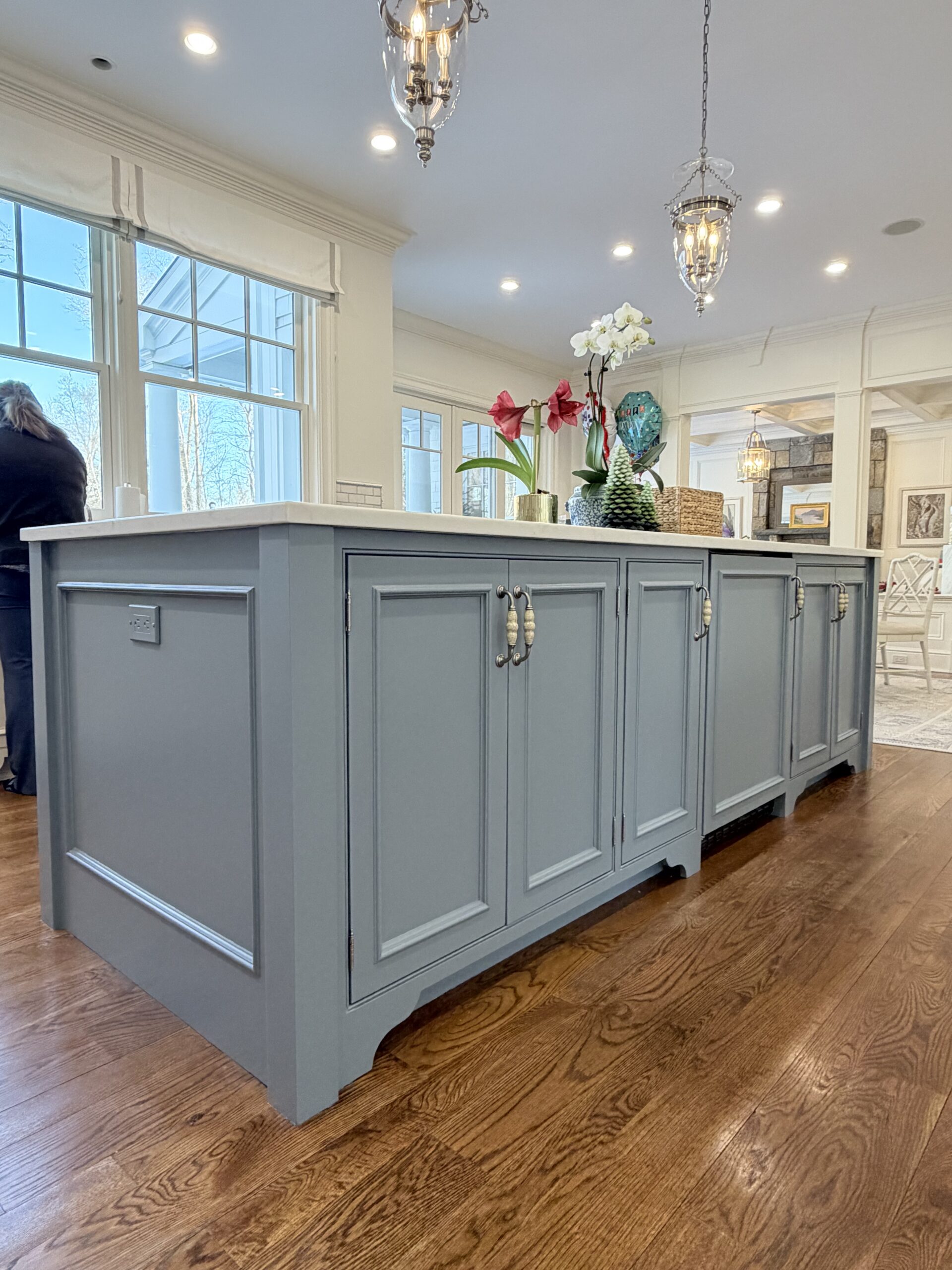Cabinet painting project in New Canaan CT with soft blue-gray island and raised panel detail